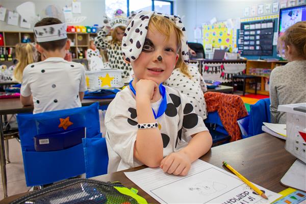 boy smiling dressed as dalmatian dog